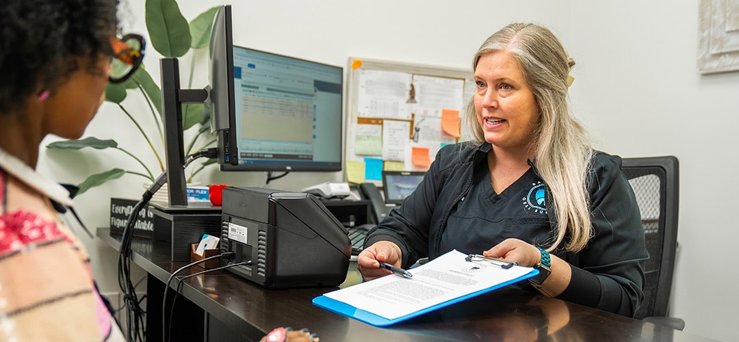 Woman helping with forms at front desk