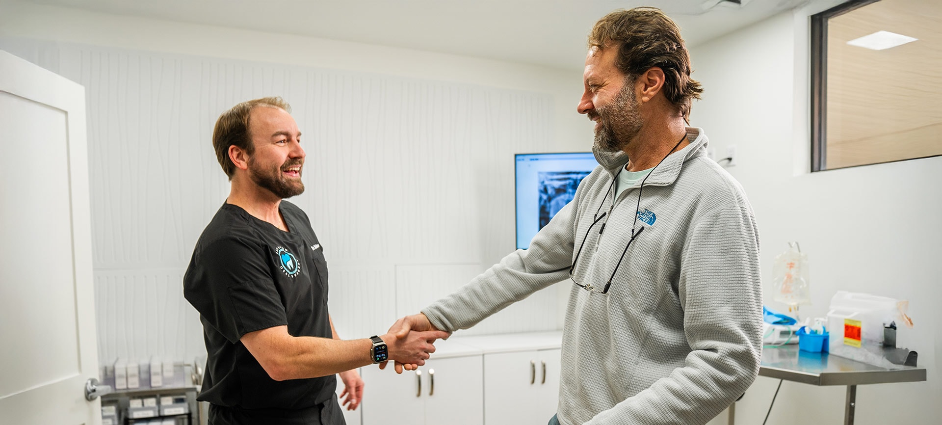 Dr. Babston shaking hands with a patient